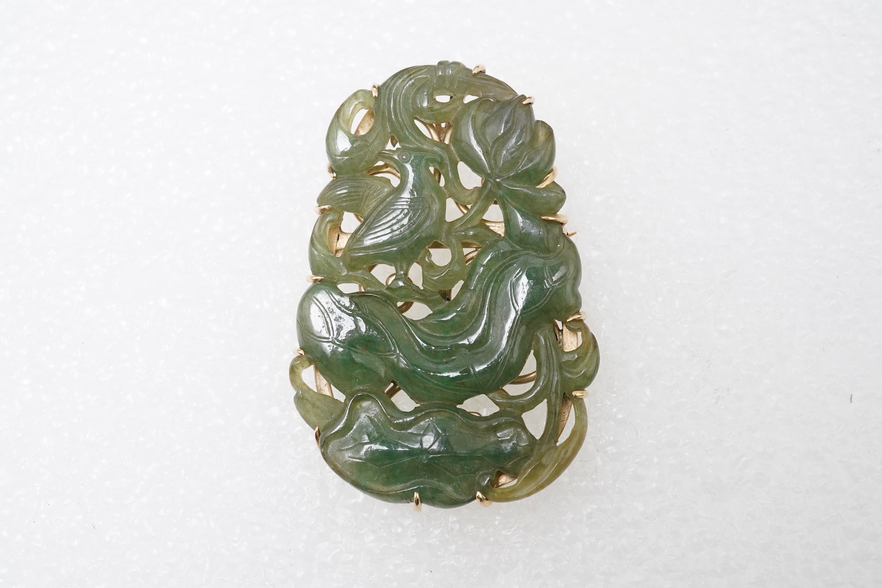 A carved jadeite brooch/pendant
